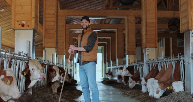 farmer is working farm with cows young man farmer cleaning cowshed barn cows eating grass background dairy farming business 299057 1699
